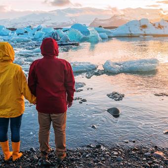 Couple at Jökulsárlón glacier lagoon at sunset