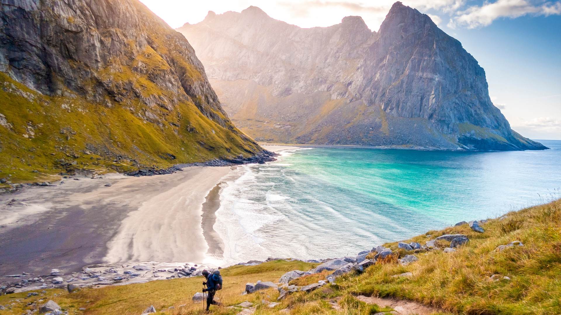 A hiker going to Kvalvika beach from Ryten, Lofoten Islands, Norway