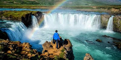 Tourist Overlooking Goðafoss Waterfall, Iceland